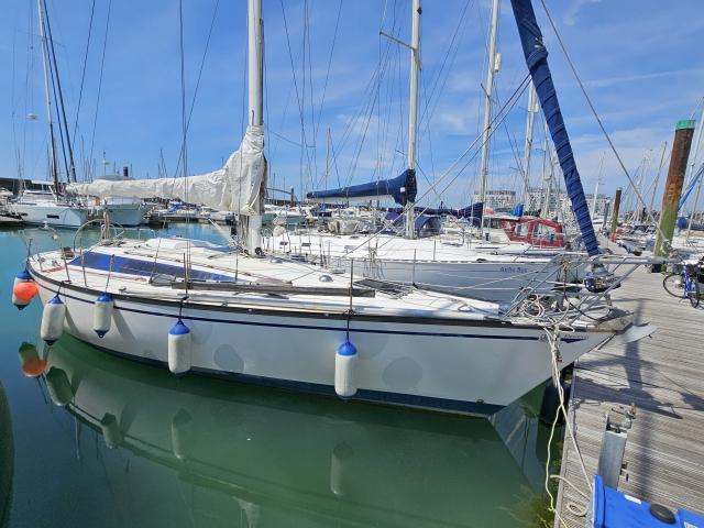 Dufour 39 1984 Dufour 39 sailboat docked in a marina, surrounded by other boats.