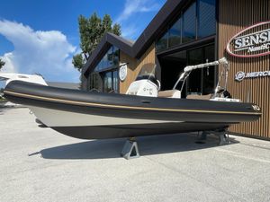 Nuova Jolly 700 XL 2019 Nuova Jolly 700 XL boat displayed outdoors near a modern building.