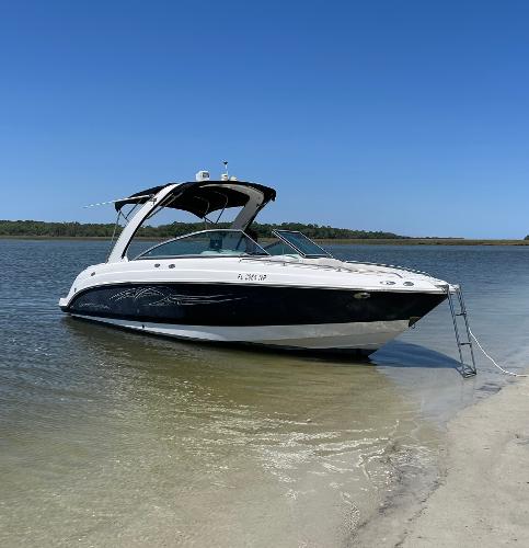 Chaparral 256 SSi 2007 Chaparral 256 SSi boat anchored on a sandy beach.