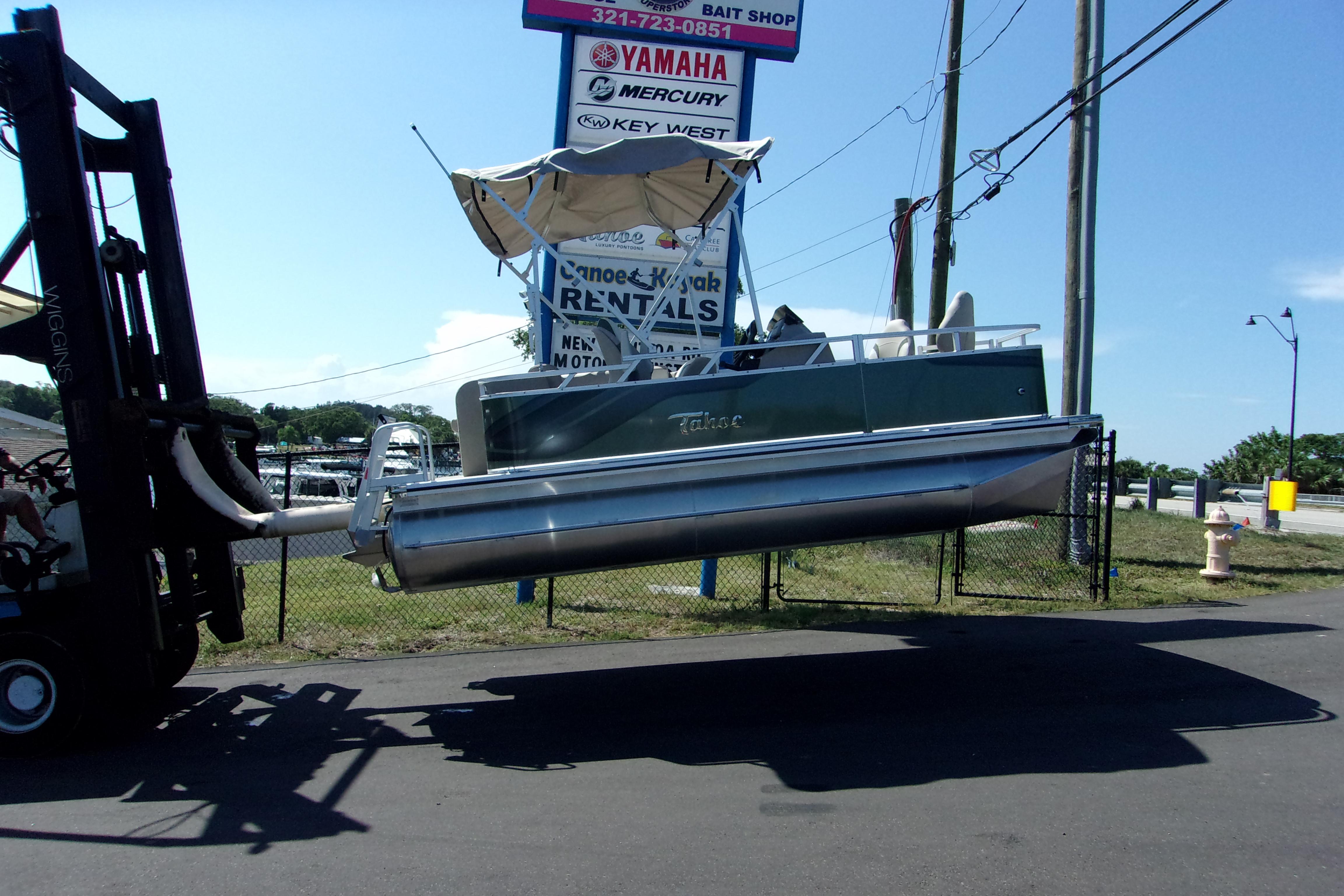Tahoe Pontoon 1775 Sport Bow 2023 Tahoe Pontoon 1775 Sport Bow being lifted by a forklift near rental shop.