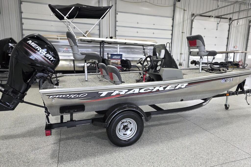 Tracker Pro 160 2016 Tracker Pro 160 boat with Mercury engine in a showroom.