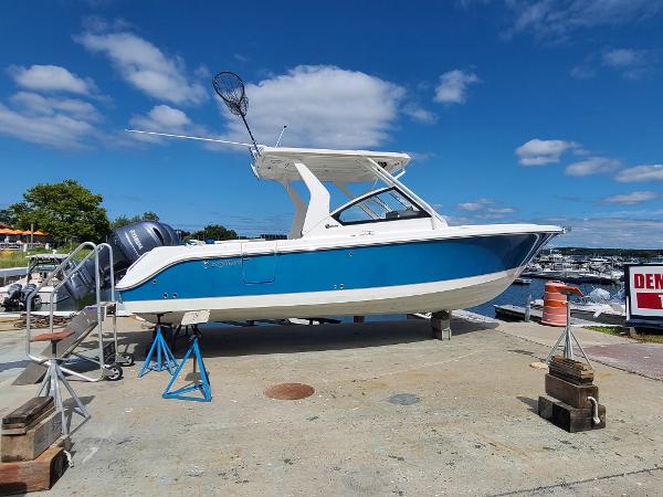 Edgewater 262 CX 2018 Edgewater 262 CX boat on dry dock, blue and white hull, sunny day.