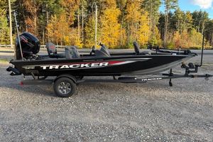 Tracker Pro Team 190 2026 Tracker Pro Team 190 boat on trailer, parked with autumn trees in background.