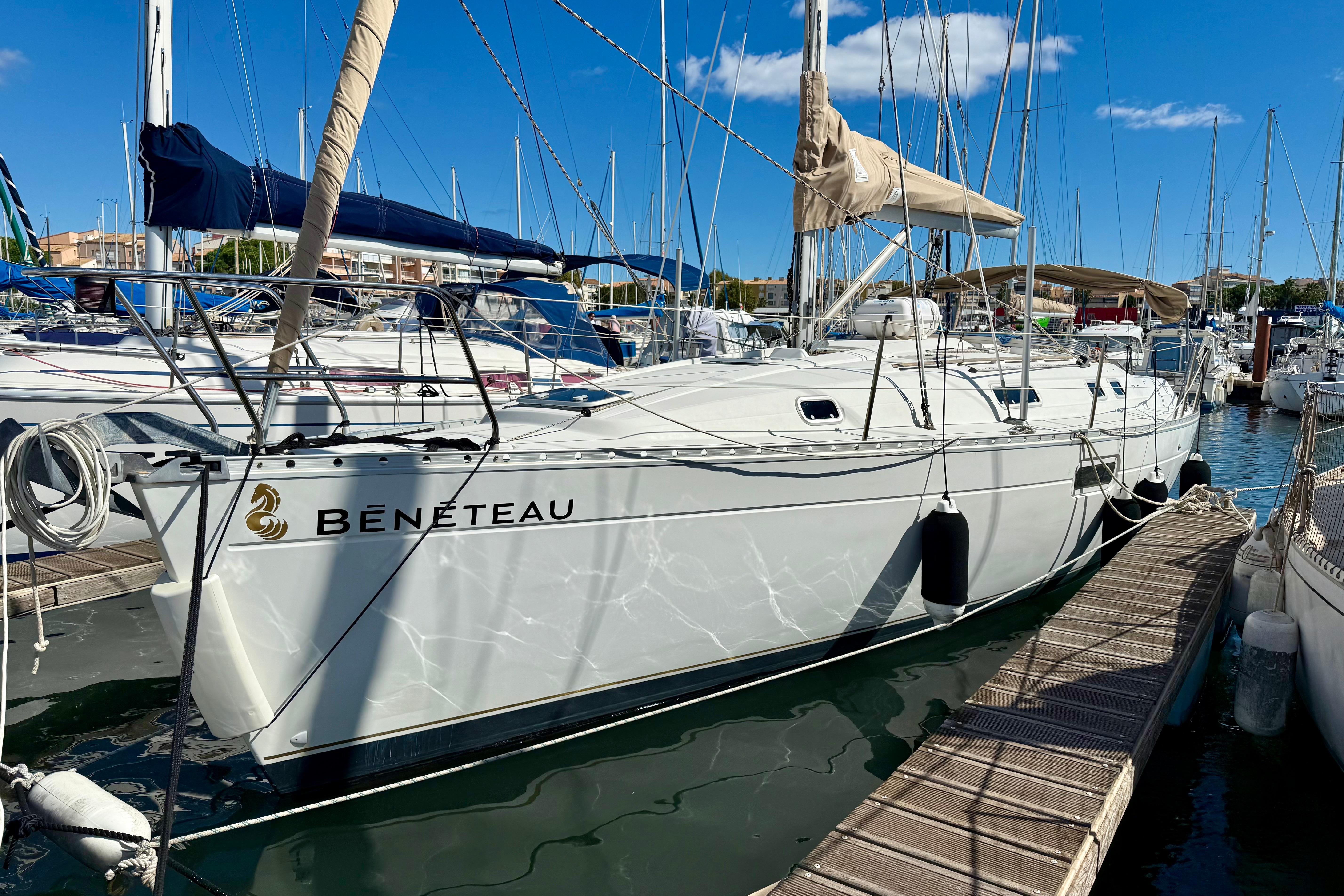 Beneteau Oceanis 351 1998 Beneteau Oceanis 351 sailboat docked in marina under clear blue sky.