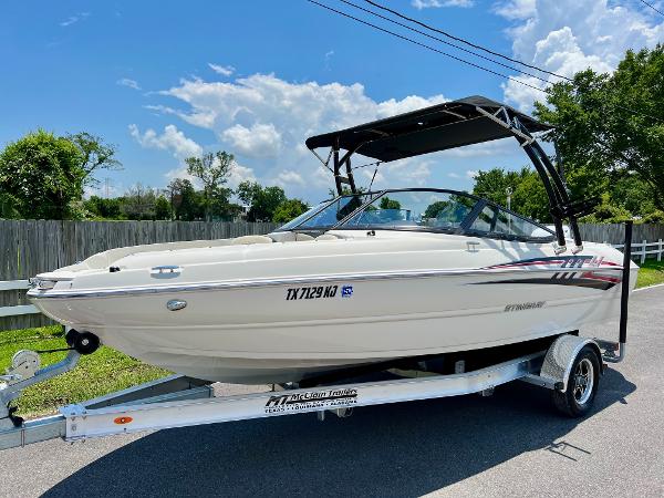 Stingray 204 LR 2021 Stingray 204 LR boat on a trailer with a black canopy.