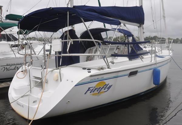 Catalina 320 1996 Catalina 320 sailboat named "Firefly" docked in a marina.