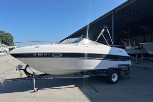 Four Winns 205 Sundowner 2002 Four Winns 205 Sundowner boat on trailer in sunny marina setting.