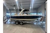 Chris-Craft Launch 25GT 2024 Chris-Craft Launch 25GT boat on trailer in showroom.