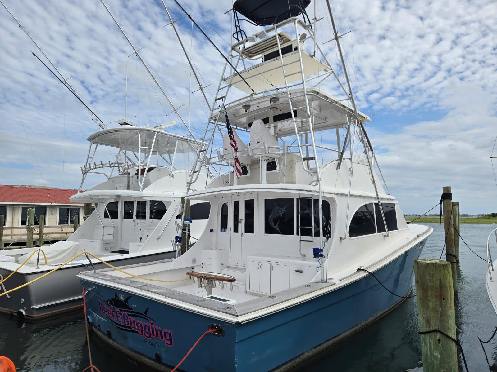 Topaz 44 Flybridge 1988 Topaz 44 Flybridge yacht docked, featuring a spacious deck and flybridge under a cloudy sky.