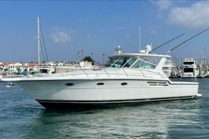 Tiara Yachts 4100 Open 2000 Tiara 41 Open yacht on water near marina, clear sky background.