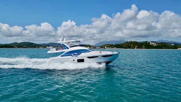 Azimut 60 Flybridge 2019 Azimut 60 Flybridge yacht cruising on clear blue water.