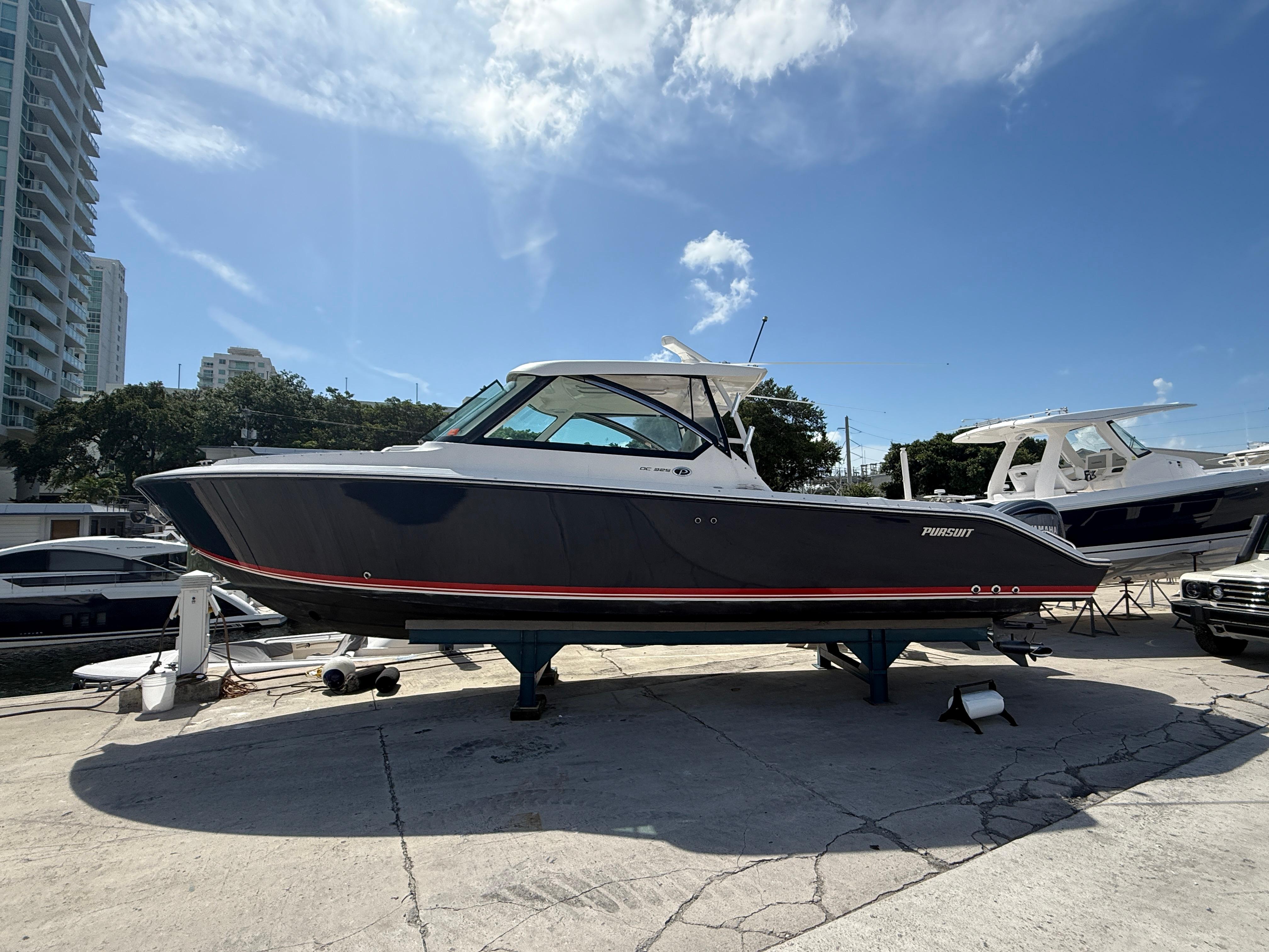 Pursuit DC 325 Dual Console 2016 Pursuit DC 325 Dual Console boat on display under a clear blue sky.