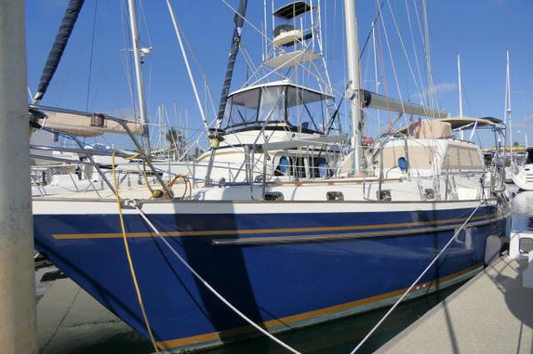 Tayana 460 Vancouver Pilothouse 2002 Tayana 460 Vancouver Pilothouse sailboat docked in marina, blue hull, sunny day.