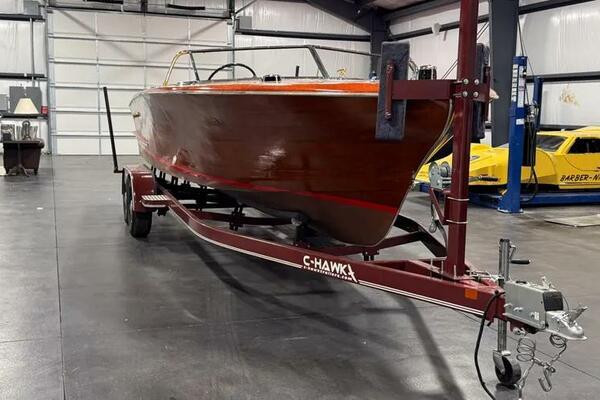 Chris-Craft Continental 28 1956 Chris-Craft Continental 28 boat on trailer in a garage setting.