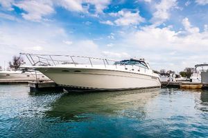 Sea Ray 500 Sundancer 1994 Sea Ray 500 Sundancer yacht docked in a marina under a blue sky.