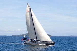 Deerfoot 74 Pilothouse Deerfoot 74 Pilothouse 1986 sailboat cruising on open water with American flag.