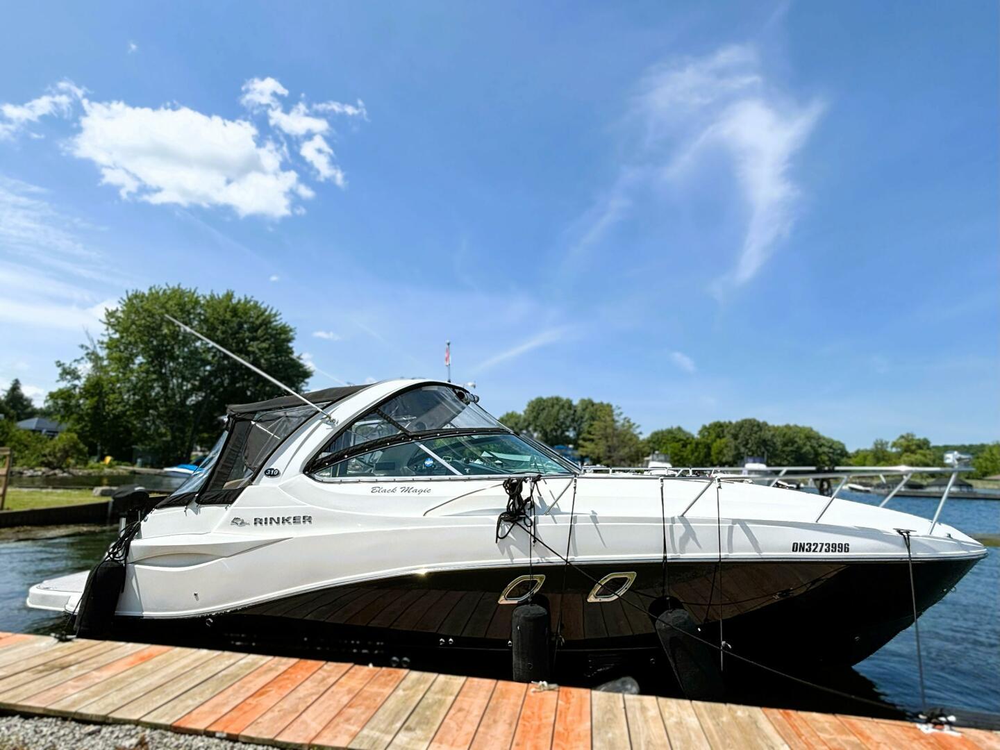 Rinker 310 Fiesta Vee 2012 Rinker 310 Fiesta Vee boat docked on a sunny day.