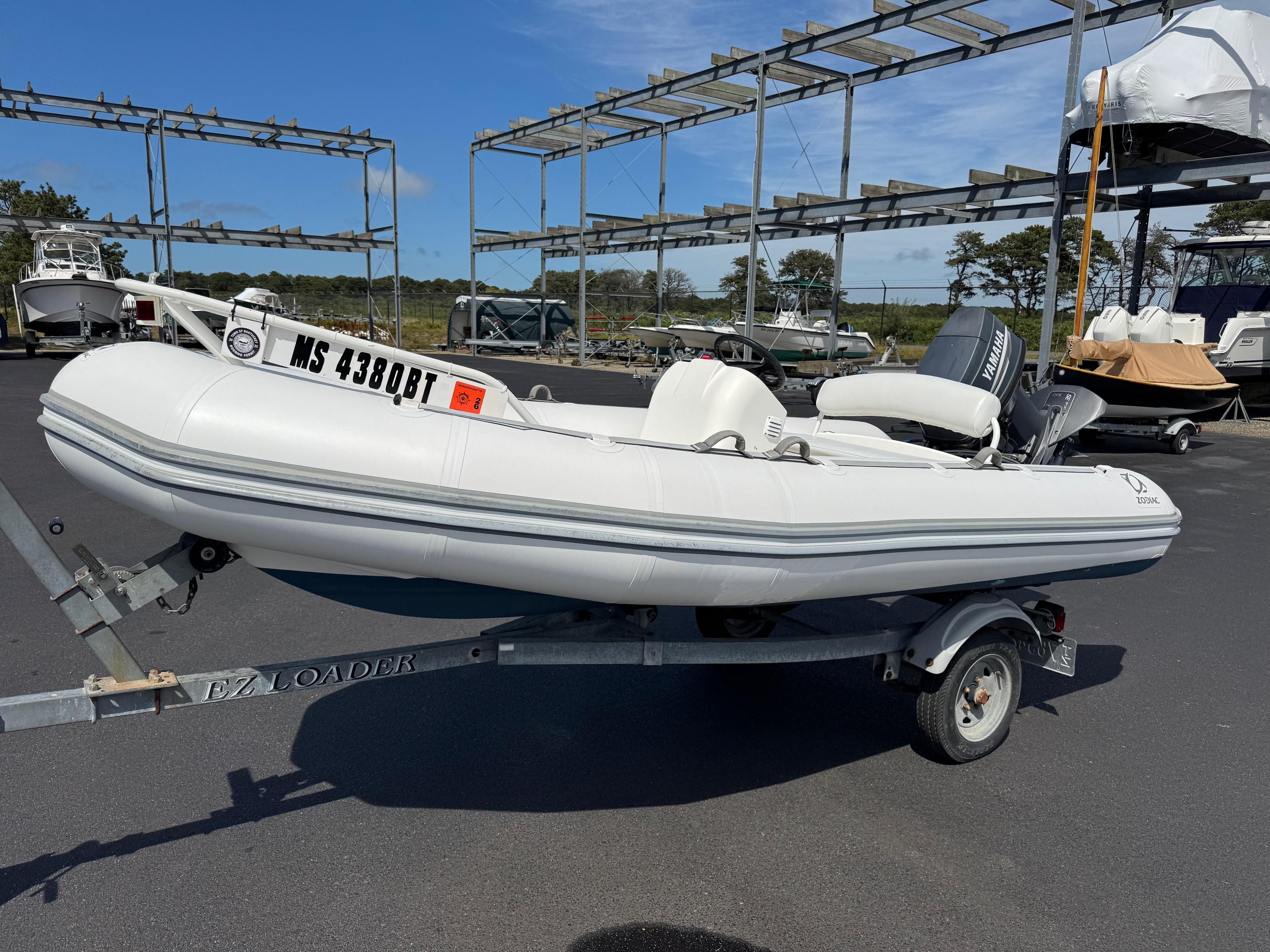 Zodiac Yachtline 420 Dl 2000 Zodiac YL 420 DL inflatable boat on trailer in a marina setting.