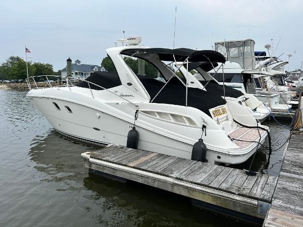 Sea Ray 330 Sundancer 2008 Sea Ray 330 Sundancer docked at marina, featuring sleek design and black canopy.
