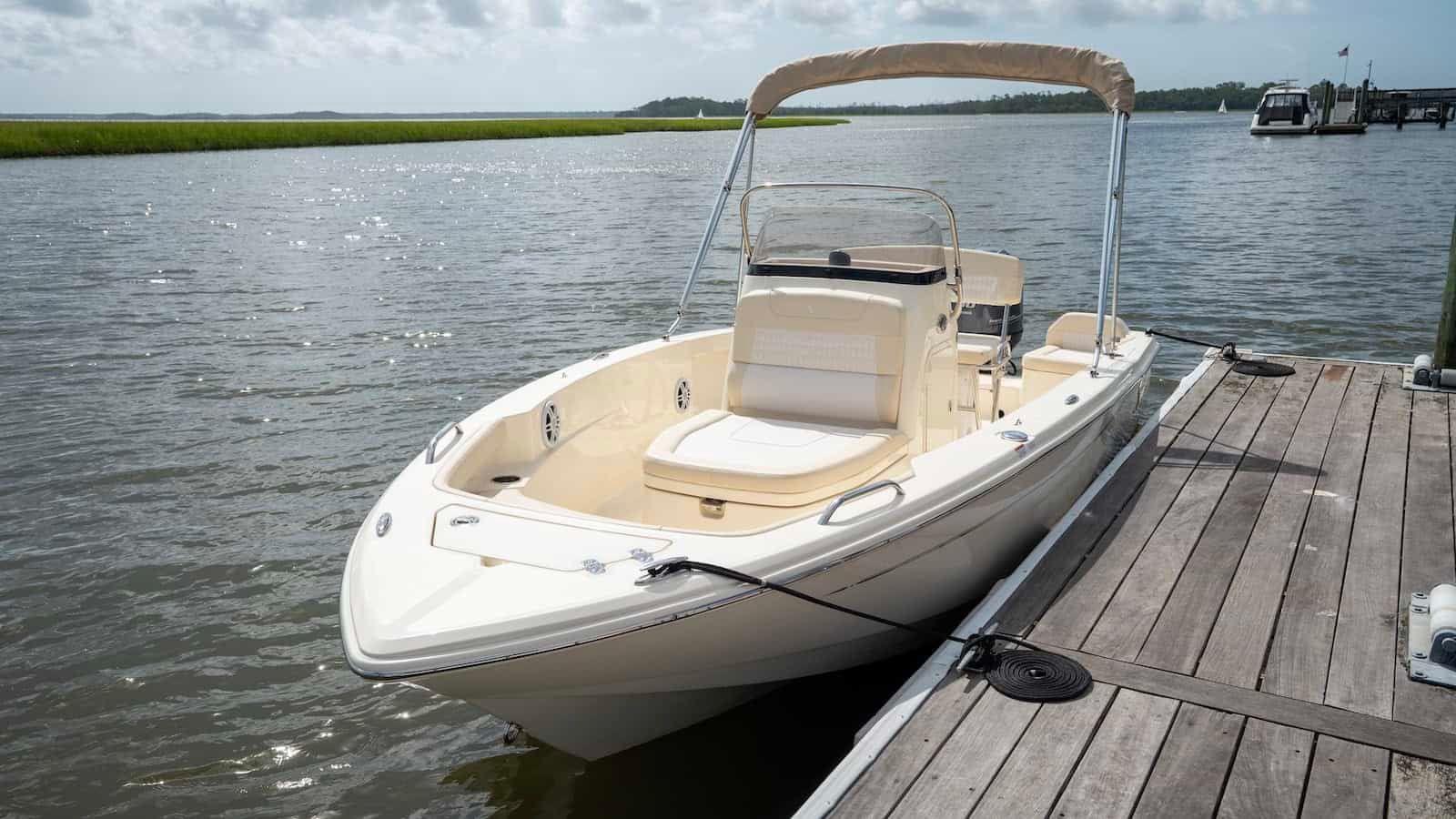 Scout 188 LXF 2026 Scout 188 LXF boat docked on a sunny day by the water.