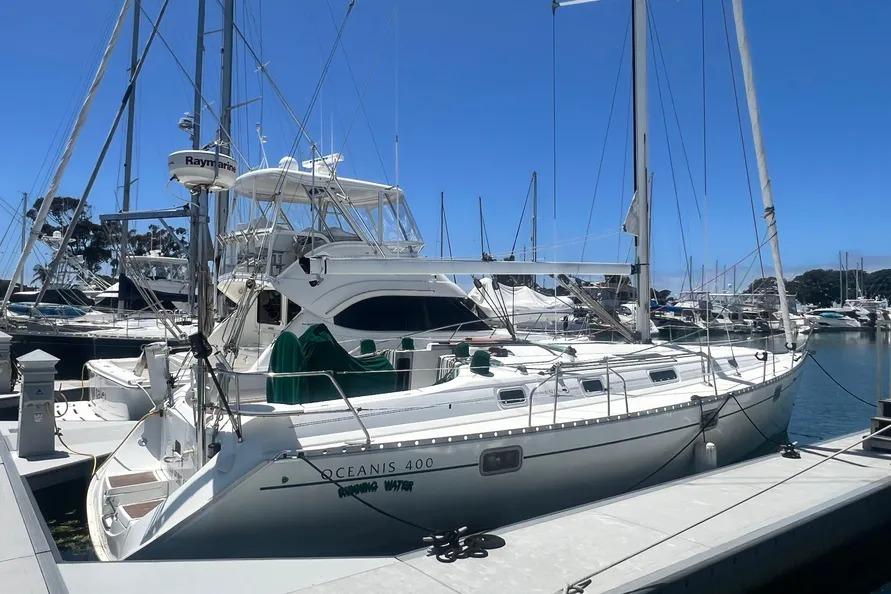 Beneteau Oceanis 400 1996 Beneteau Oceanis 400 sailboat docked at marina under clear blue sky.