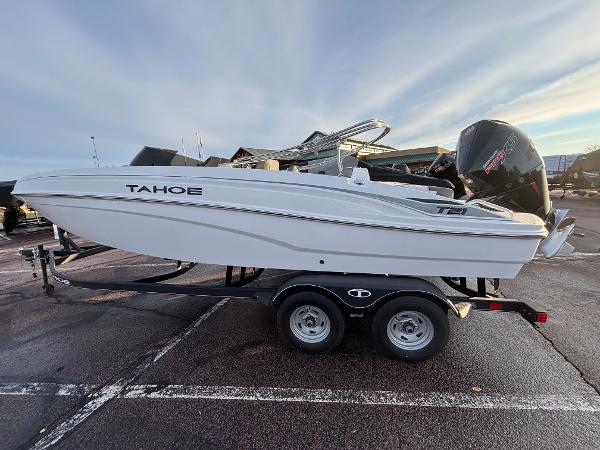 Tahoe T21 2024 Tahoe T21 boat on trailer in parking lot, side view.