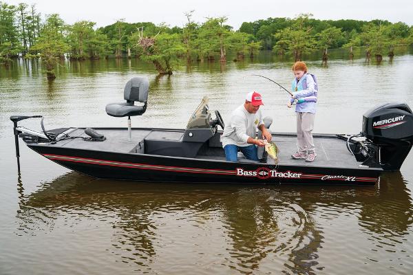 Tracker Bass Tracker Classic XL 2024 Tracker BASS TRACKER® Classic XL boat on a lake with two people fishing.