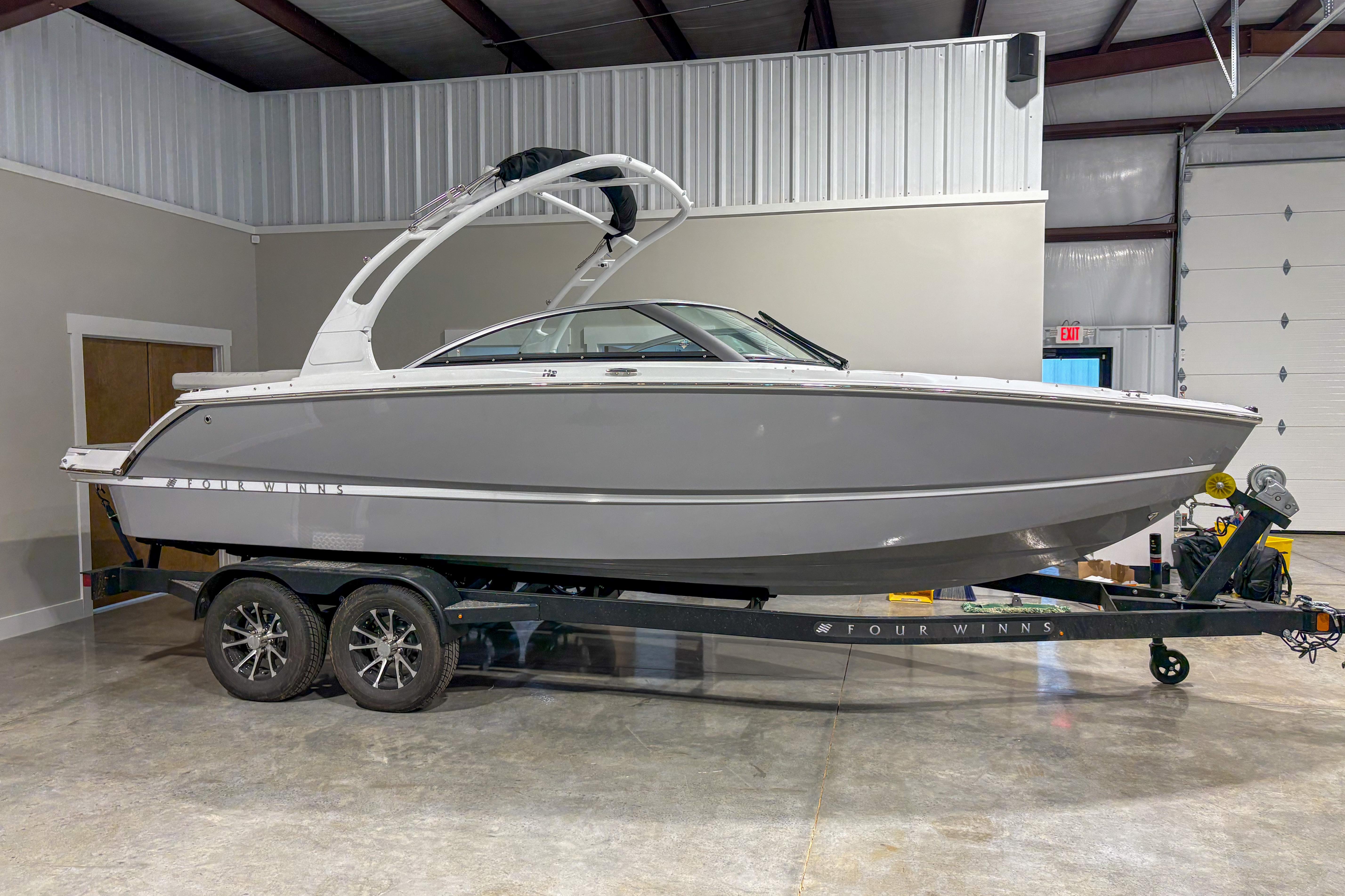 Four Winns H2 2026 Four Winns H2 boat on trailer in indoor storage facility.