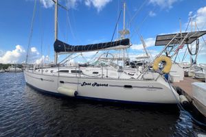 Catalina 470 1999 Catalina 470 sailboat docked at marina under blue sky.