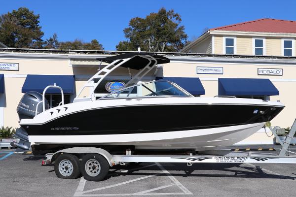 Chaparral 21 SSi OB 2023 Chaparral 21 SSi OB boat on trailer, parked outside dealership.