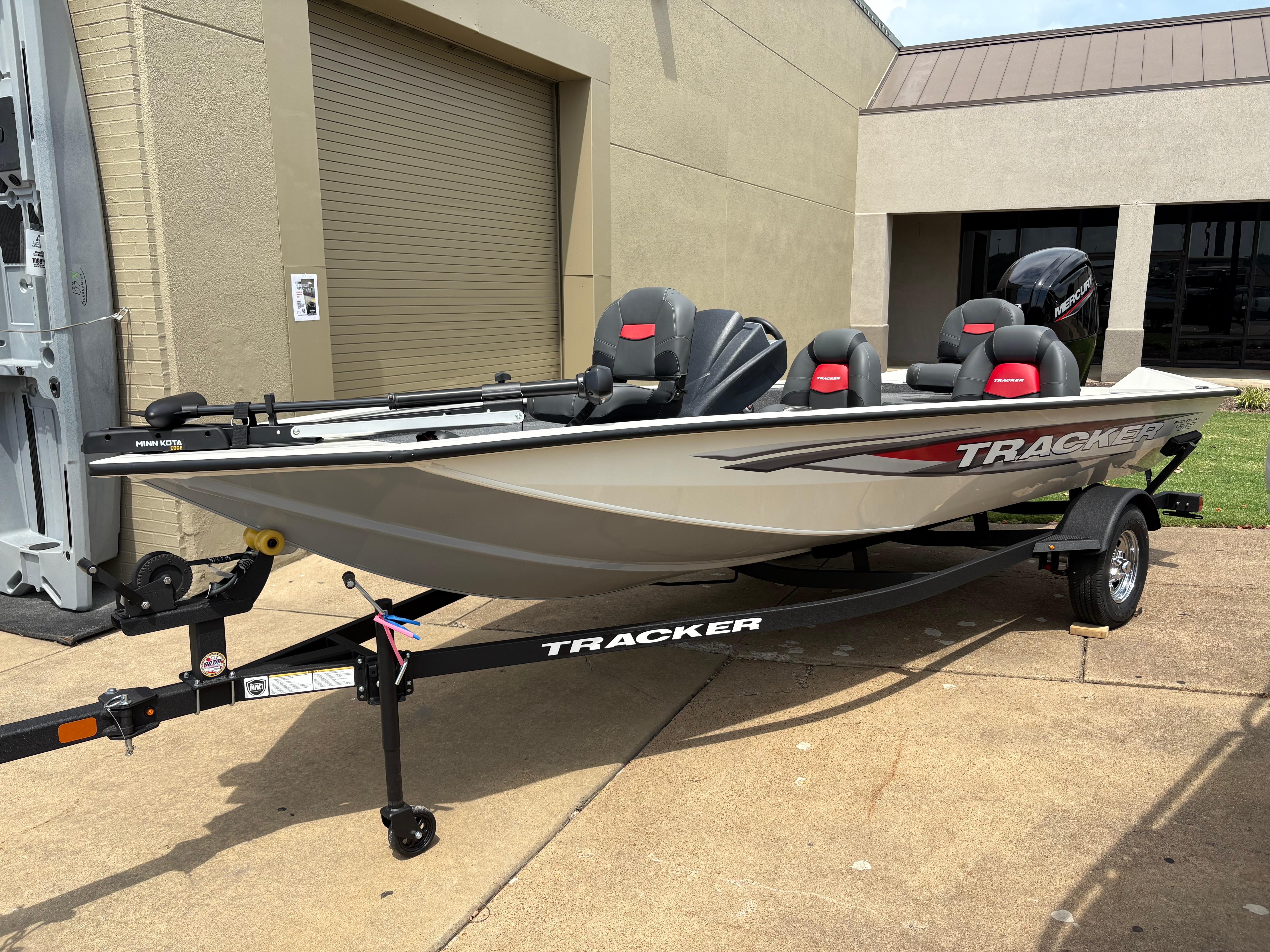 Tracker Pro Team 175 2025 Tracker Pro Team 175 boat on trailer, parked outside a building.