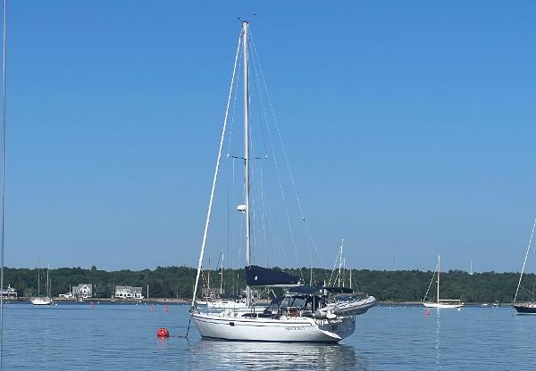 Catalina 36 MkII 1999 Catalina 36 Mk II sailboat anchored on calm water under clear blue sky.