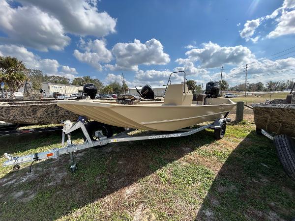 Crestliner 1860 Retriever CC Tunnel 2024 Crestliner 1860 Retriever CC Tunnel boat on trailer under a partly cloudy sky.
