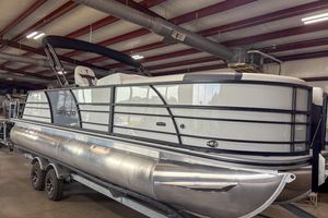 Trifecta 24UL CS 2026 Trifecta 24UL CS pontoon boat in a warehouse, showcasing sleek design and modern features.