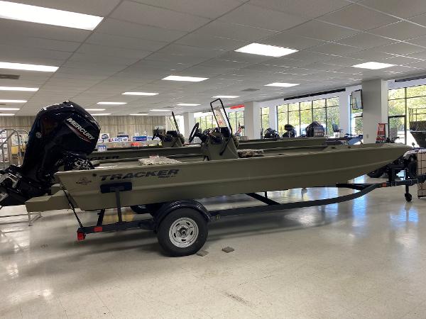 Tracker Grizzly 1860 CC 2025 Tracker Grizzly 1860 CC boat displayed indoors on a trailer.