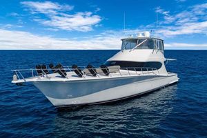 Hatteras 63GT 2016 Hatteras 63GT yacht on open sea under blue sky.