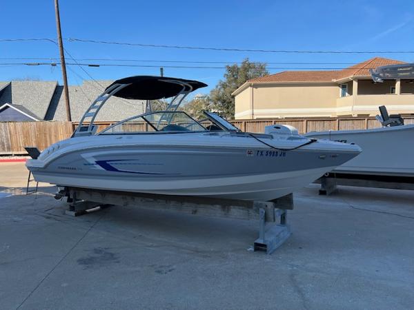 Chaparral 23 SSi 2020 Chaparral 23 SSi boat on a stand, featuring a sleek design and canopy.