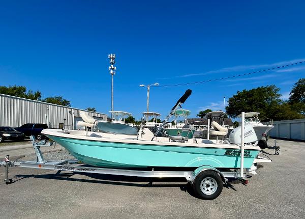 Carolina Skiff 192 JLS 2025 Carolina Skiff 192 JLS boat on trailer, parked outdoors under clear blue sky.