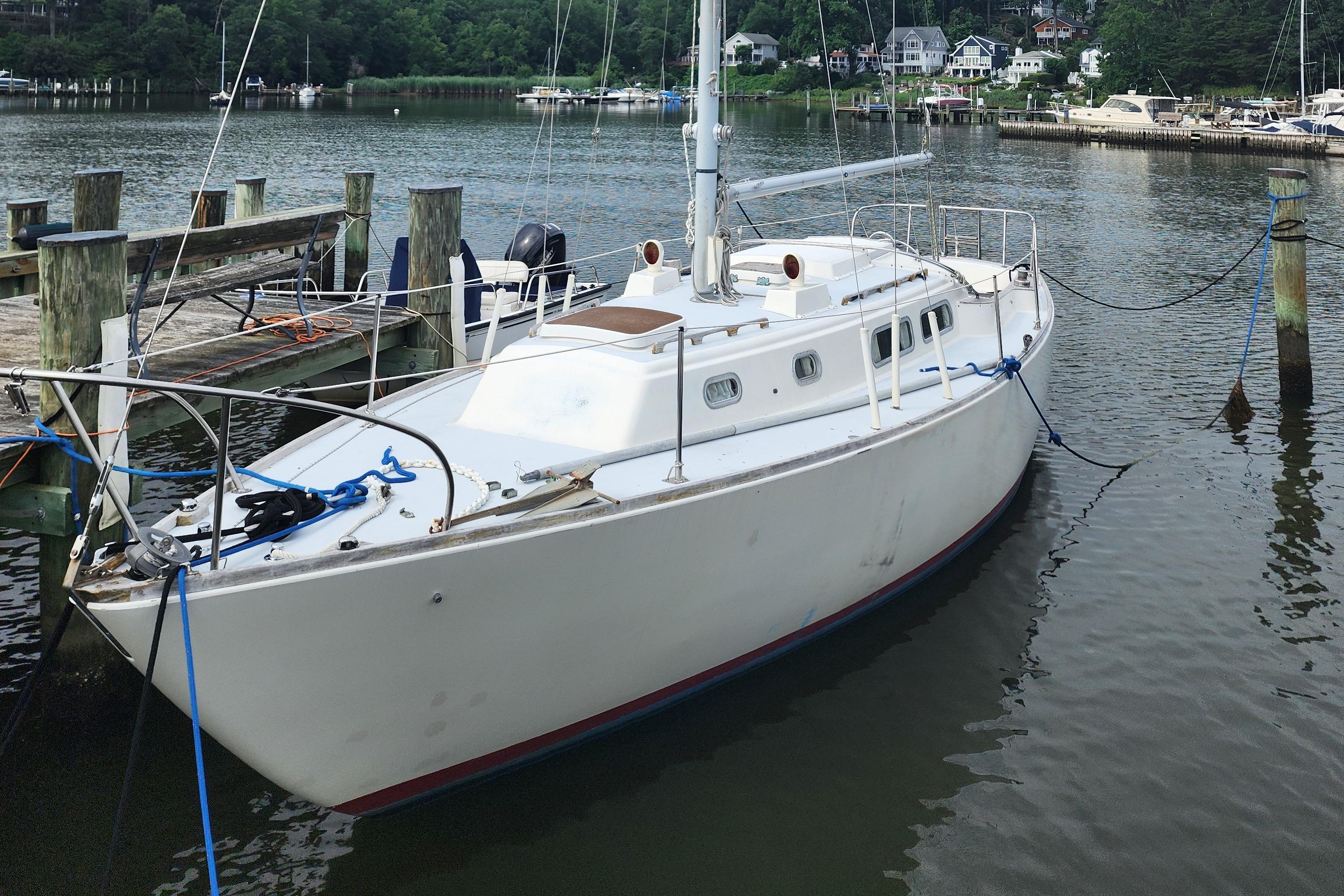 Pearson 34 1974 Pearson 34 sailboat docked at a serene marina.
