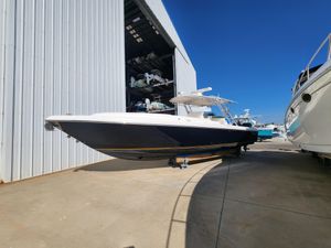 Intrepid 323 Cuddy 2008 Intrepid 323 Cuddy boat docked outside a large storage facility under clear blue skies.