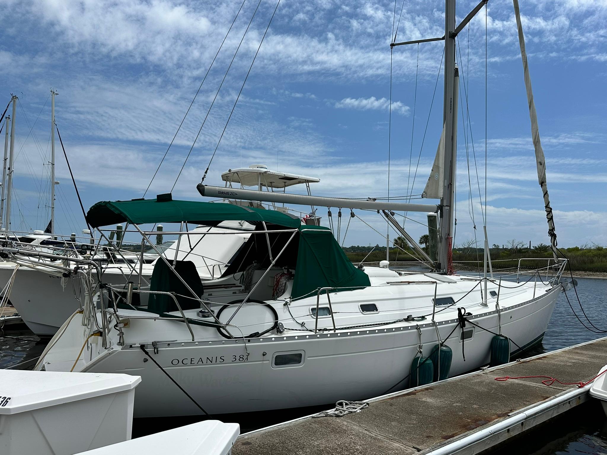 Beneteau 381 Sailboat Beneteau Oceanis 381, 1998 model, docked at marina under blue sky.