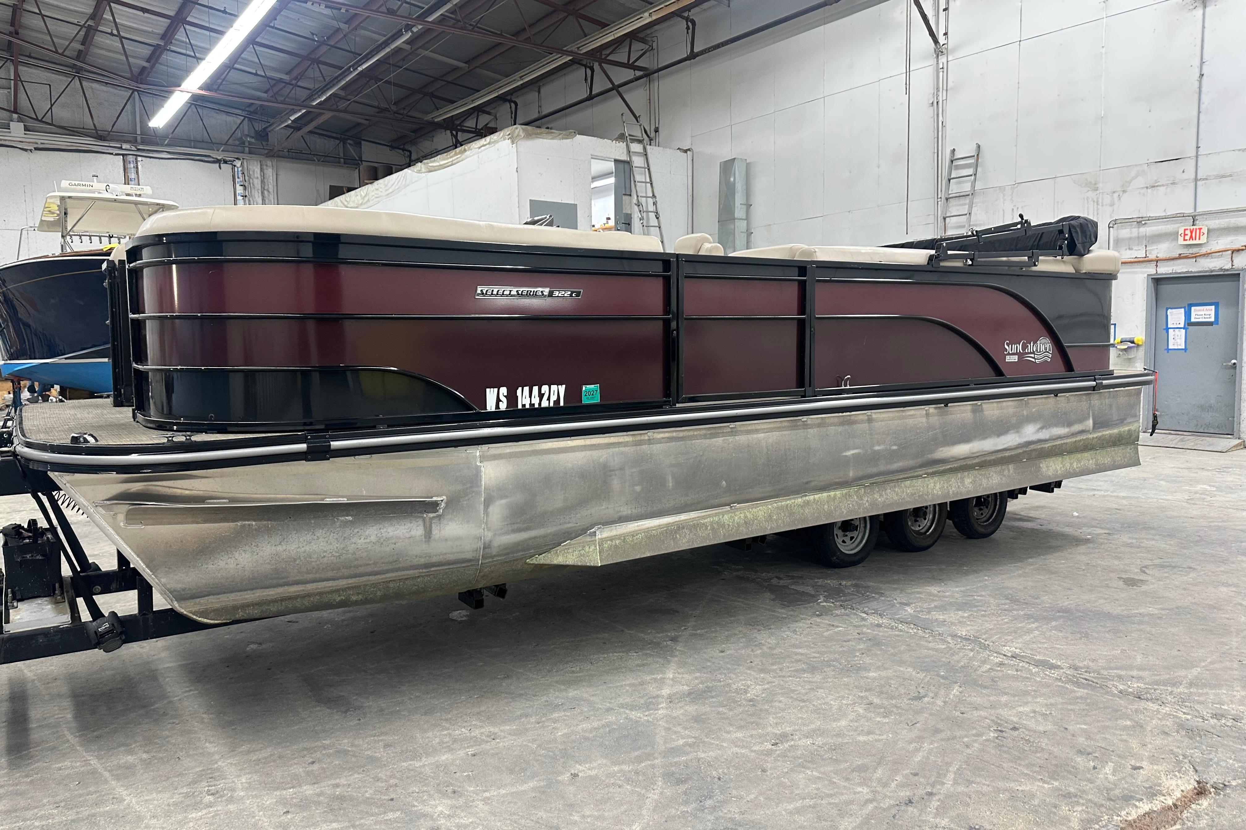 SunCatcher Select Series 322C 2021 SunCatcher Select Series 322C pontoon boat in a warehouse setting.