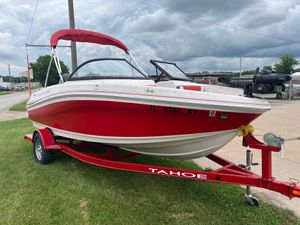 Tahoe Tahoe 450 TF Red 2016 Tahoe 450 TF boat on trailer, parked on grass under cloudy sky.
