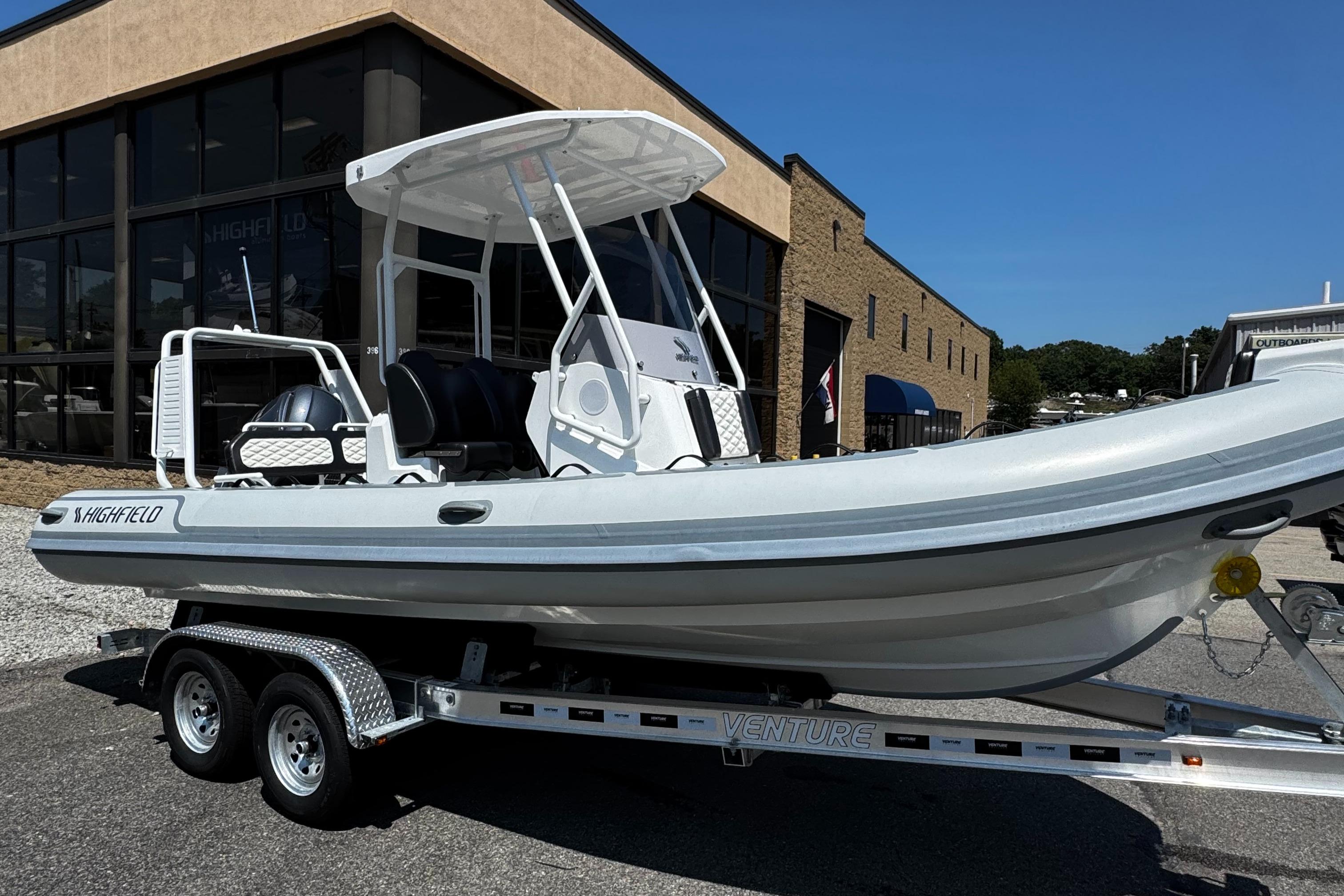 Highfield Sport 660 2025 Highfield Sport 660 boat on trailer outside dealership.