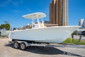 Sea Hunt Ultra 225 2017 Sea Hunt Ultra 225 boat on trailer, urban backdrop, clear sky.