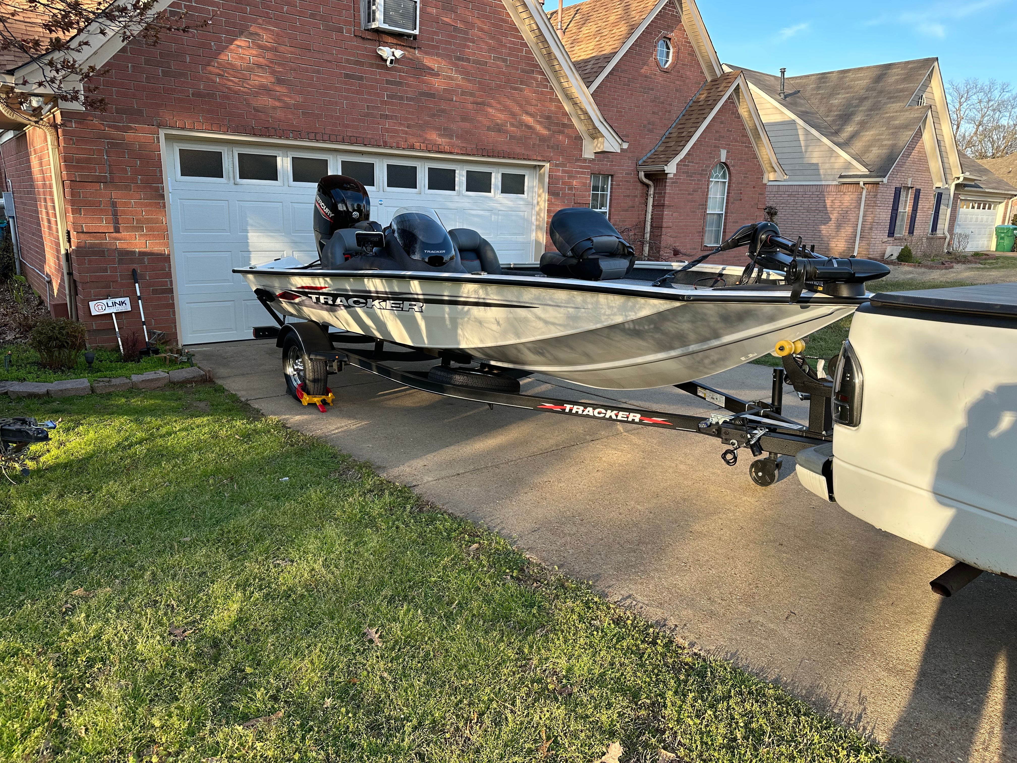 Tracker Pro 175 2023 Tracker Pro 175 boat on trailer in suburban driveway.