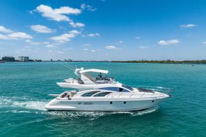 Azimut 50 Flybridge 2008 Azimut Fly 50 yacht cruising on turquoise waters under a clear blue sky.