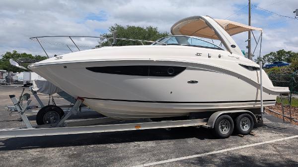 Sea Ray 260 Sundancer 2014 Sea Ray 260 Sundancer boat on trailer, parked outdoors under cloudy sky.