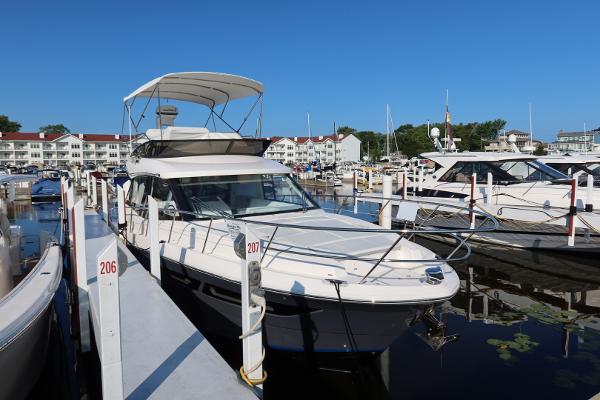 Regal 38 Fly 2024 Regal 38 Fly yacht docked at marina under clear blue sky.