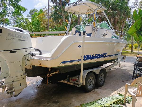 Wellcraft Coastal 264 1997 Wellcraft 264 Coastal boat on trailer with Suzuki outboard motor.